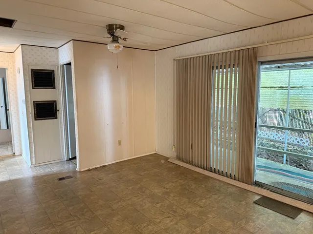 an empty room with windows and closet