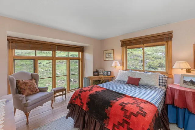 a bedroom with a bed and a large window