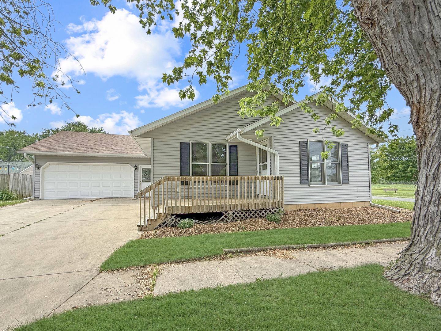 a front view of a house with a garden and yard