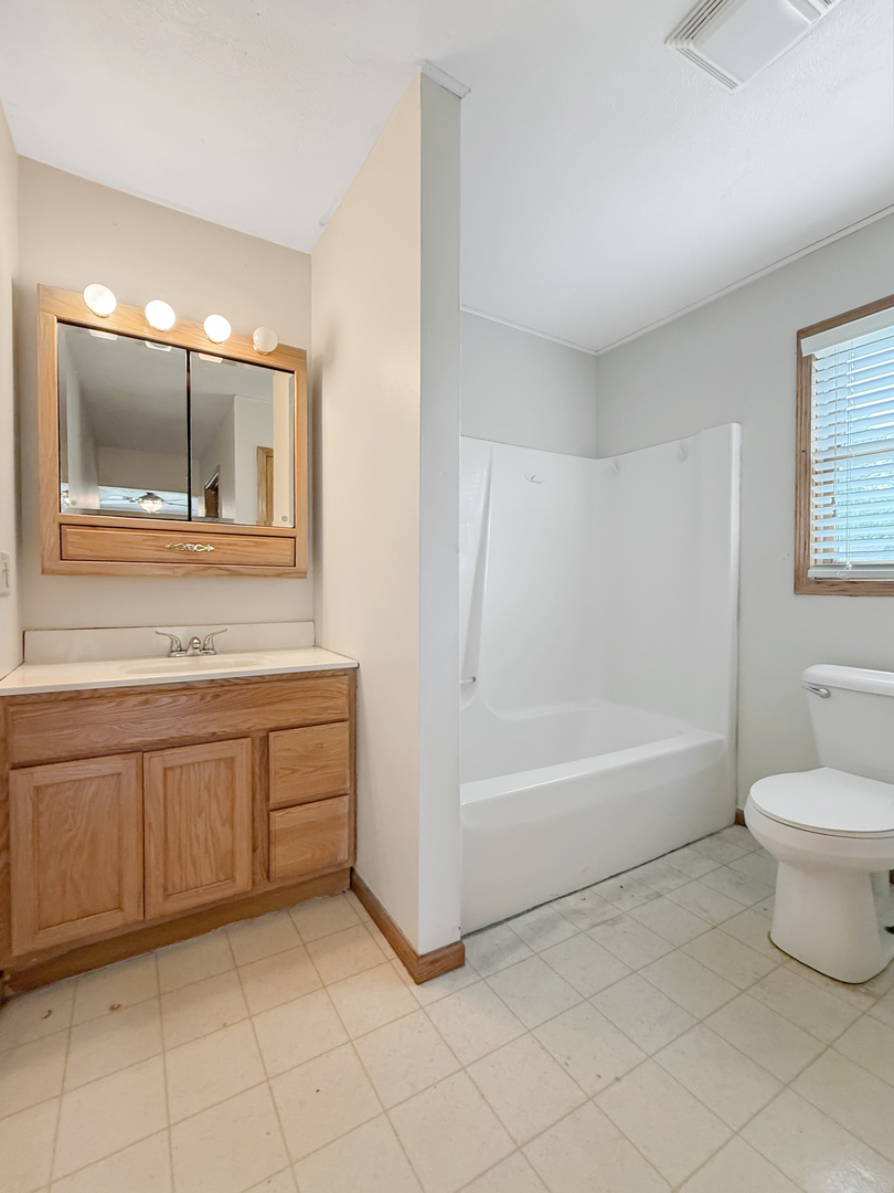 100 Adams Street Ridott, IL 61067 - Photo 13 of 17 a bathroom with a sink a toilet and bathtub
