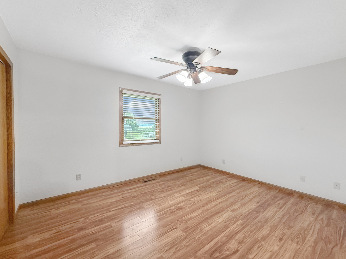 100 Adams Street Ridott, IL 61067 - Photo 16 of 17 a view of a big room with wooden floor and a window