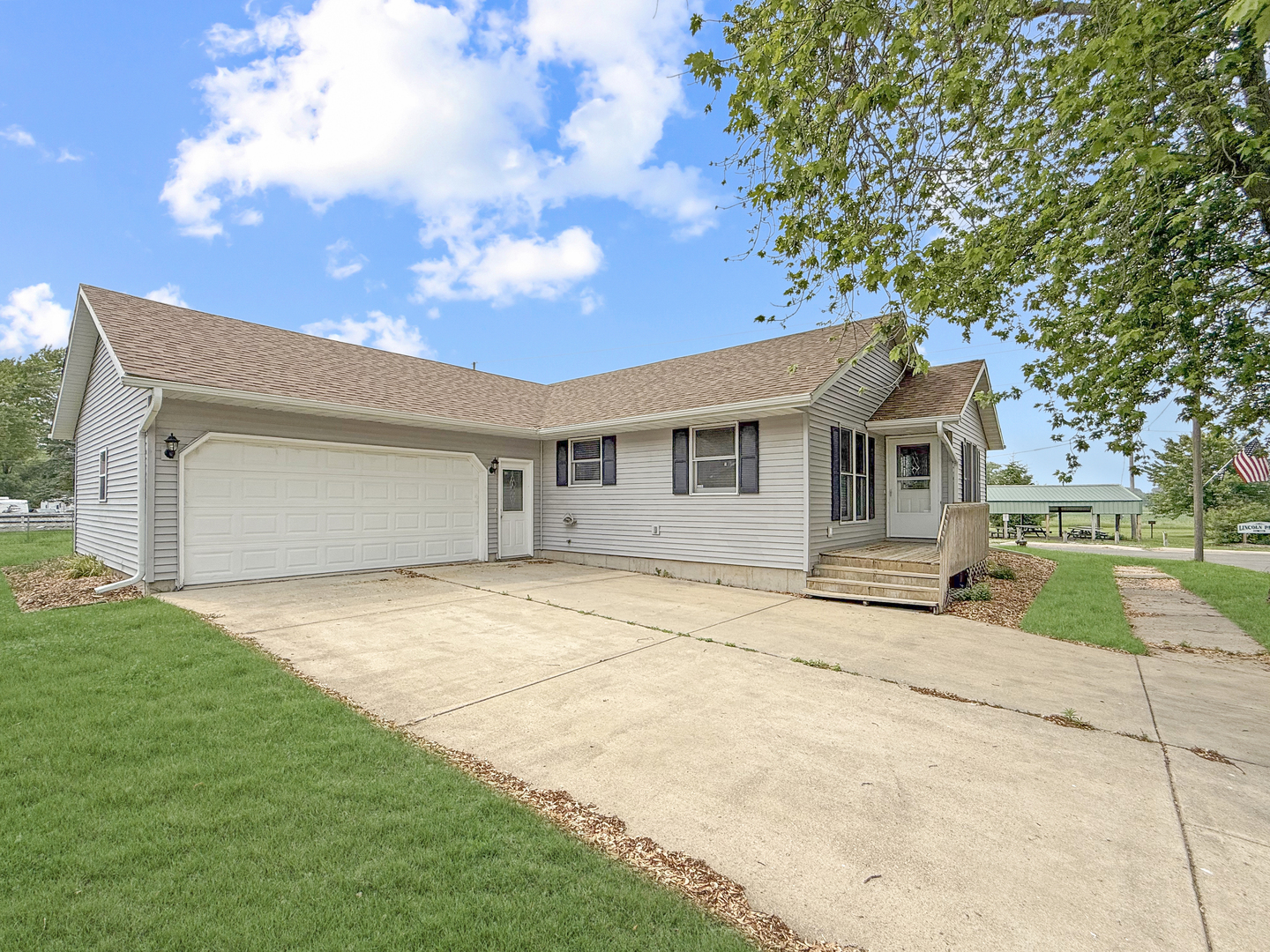 100 Adams Street Ridott, IL 61067 - Photo 17 of 17 a front view of a house with a yard and garage