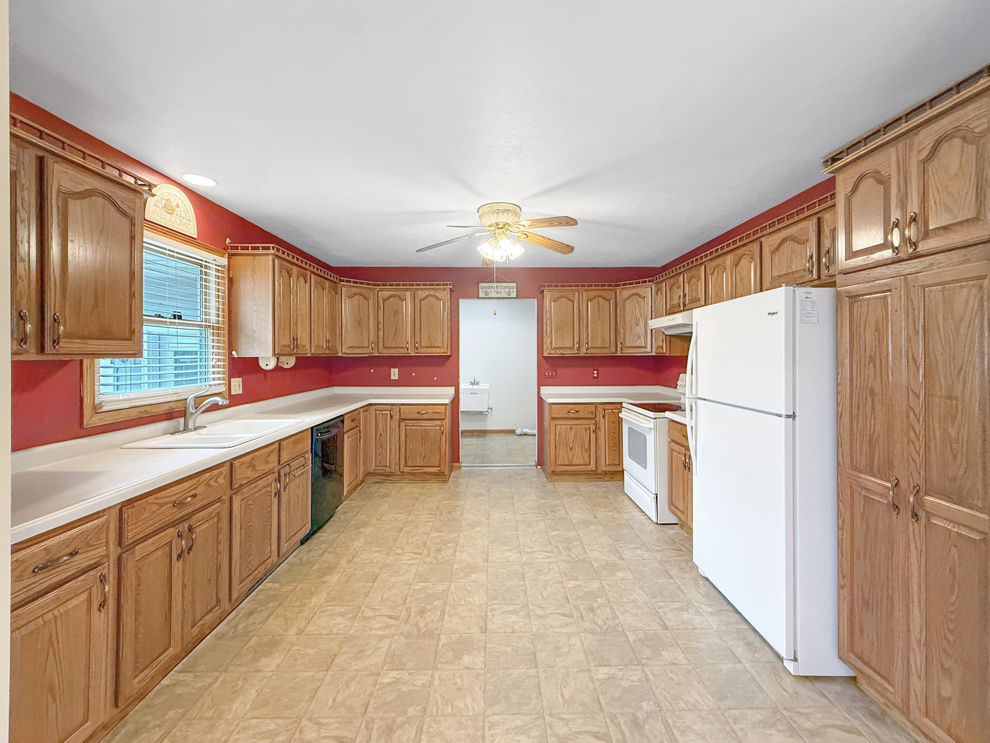100 Adams Street Ridott, IL 61067 - Photo 3 of 17 a kitchen with a sink a refrigerator and cabinets