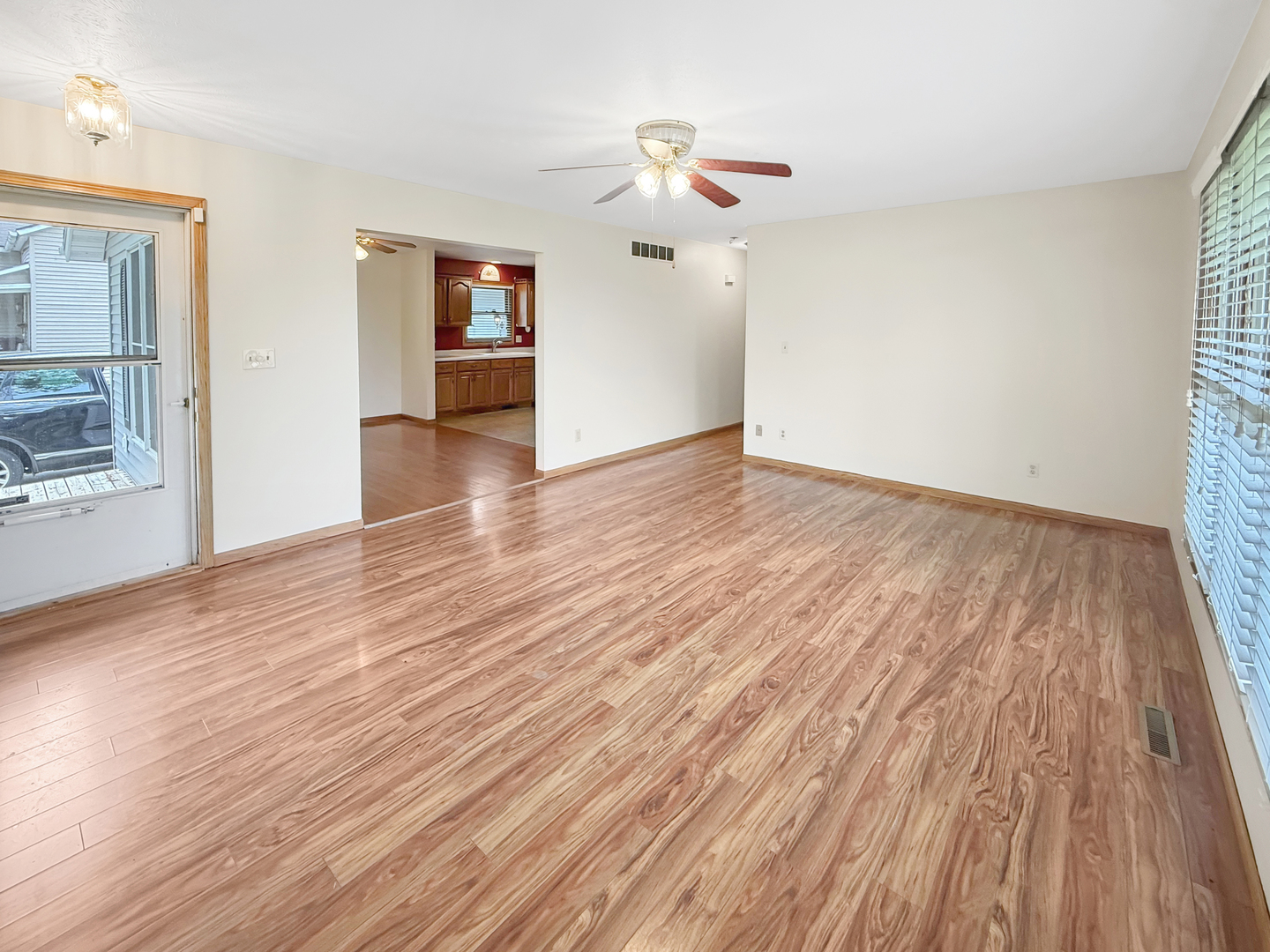 100 Adams Street Ridott, IL 61067 - Photo 5 of 17 an empty room with wooden floor and windows