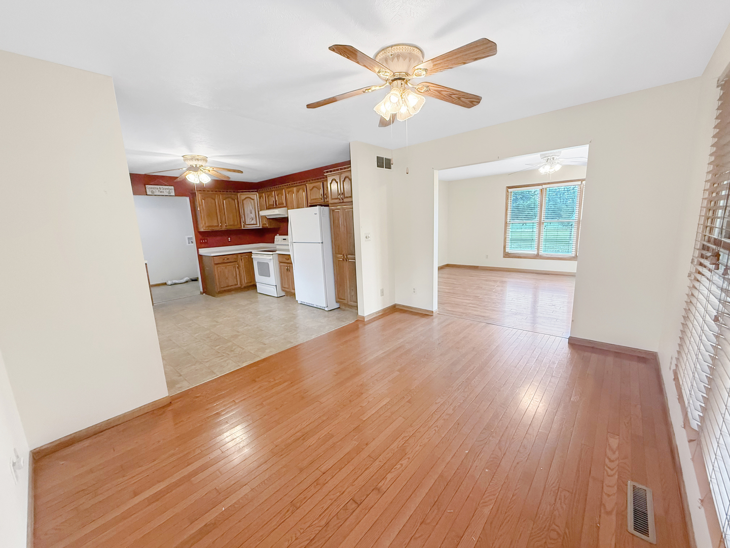 100 Adams Street Ridott, IL 61067 - Photo 7 of 17 a view of an empty room with a window and wooden floor