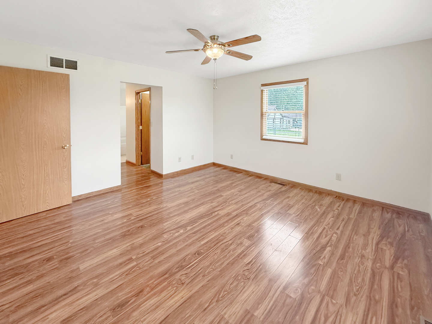 100 Adams Street Ridott, IL 61067 - Photo 10 of 17 an empty room with wooden floor and a ceiling fan
