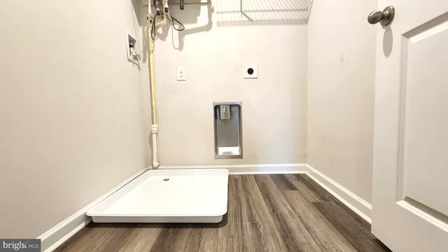 a view of a room with wooden floor