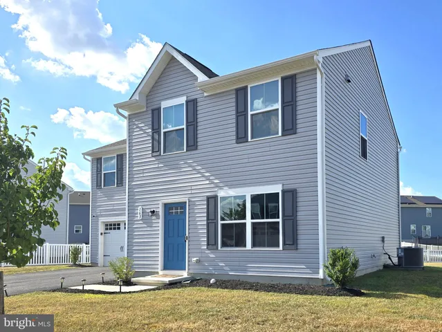 a front view of a house with a yard garage and outdoor seating