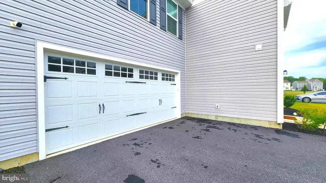 a view of a house with a yard and garage