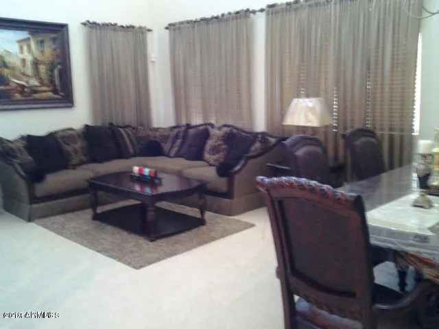 a living room with furniture and a curtain