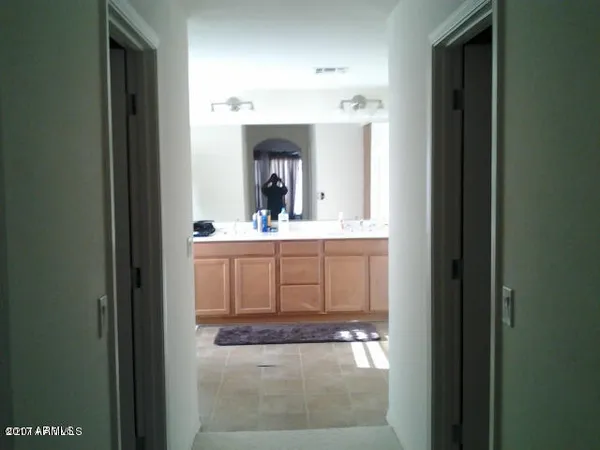 a bathroom with double sink and a mirror