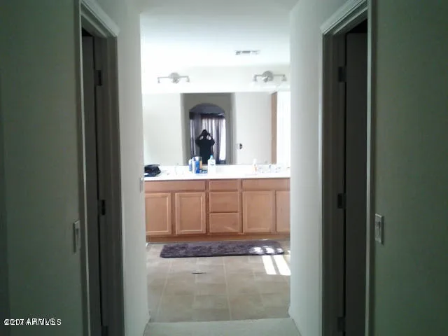 a bathroom with double sink and a mirror