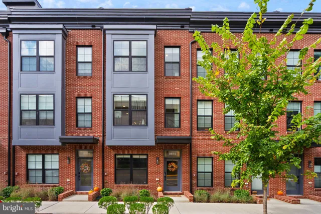 a living room with stainless steel appliances kitchen island granite countertop furniture and a view of kitchen