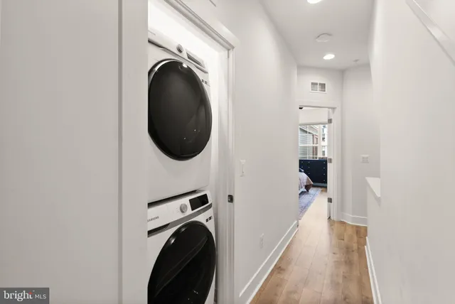 a view of entryway and hall with wooden floor