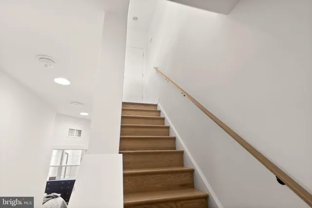 a bedroom with a bed and the view of living room