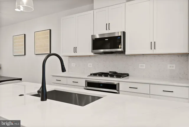 a kitchen with a refrigerator a sink and wooden cabinets