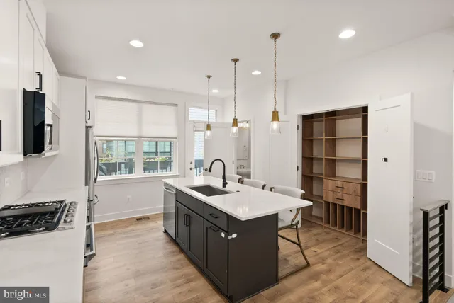 a view of a dining room with furniture a chandelier and wooden floor