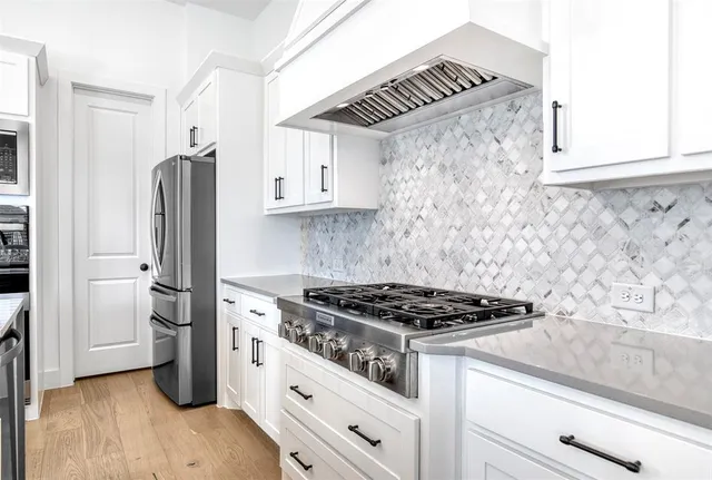 a kitchen with granite countertop a cabinets and a stove