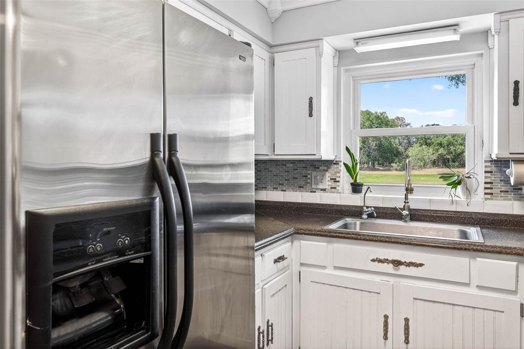 16330 Hanna Road Lutz, FL 33549 - Photo 14 of 41 a kitchen with a sink and a refrigerator