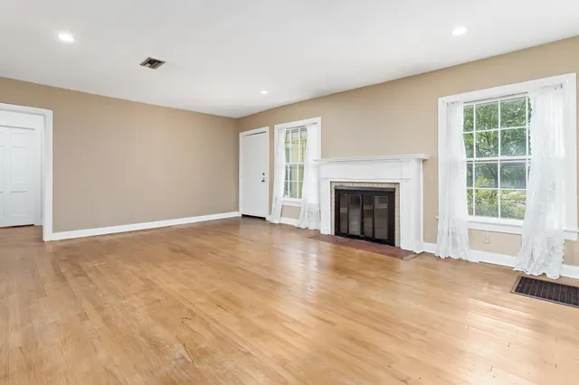 a view of empty room with a fireplace