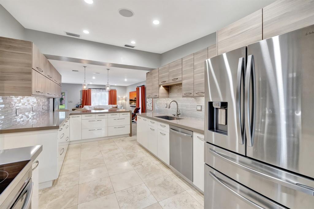 201 Northeast 28th Court Wilton Manors, FL 33334 - Photo 16 of 83 a kitchen with stainless steel appliances a refrigerator sink and cabinets