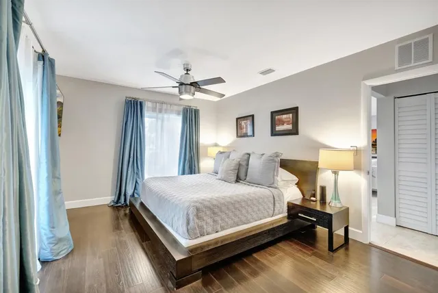 a bedroom with a bed and a painting