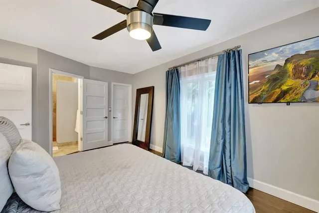 a bedroom with a large bed and a window