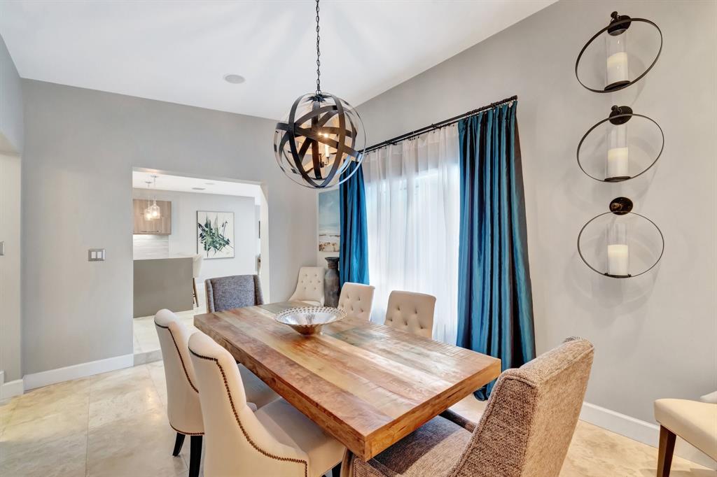 201 Northeast 28th Court Wilton Manors, FL 33334 - Photo 37 of 83 a view of a dining room with furniture wooden floor and chandelier