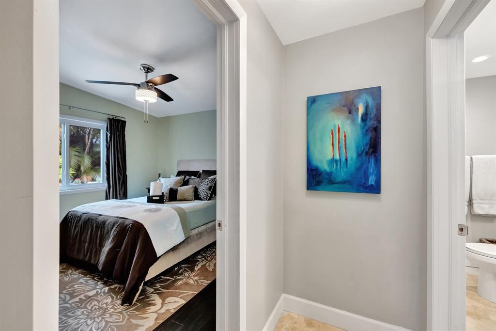 201 Northeast 28th Court Wilton Manors, FL 33334 - Photo 38 of 83 a bedroom with a bed and a painting