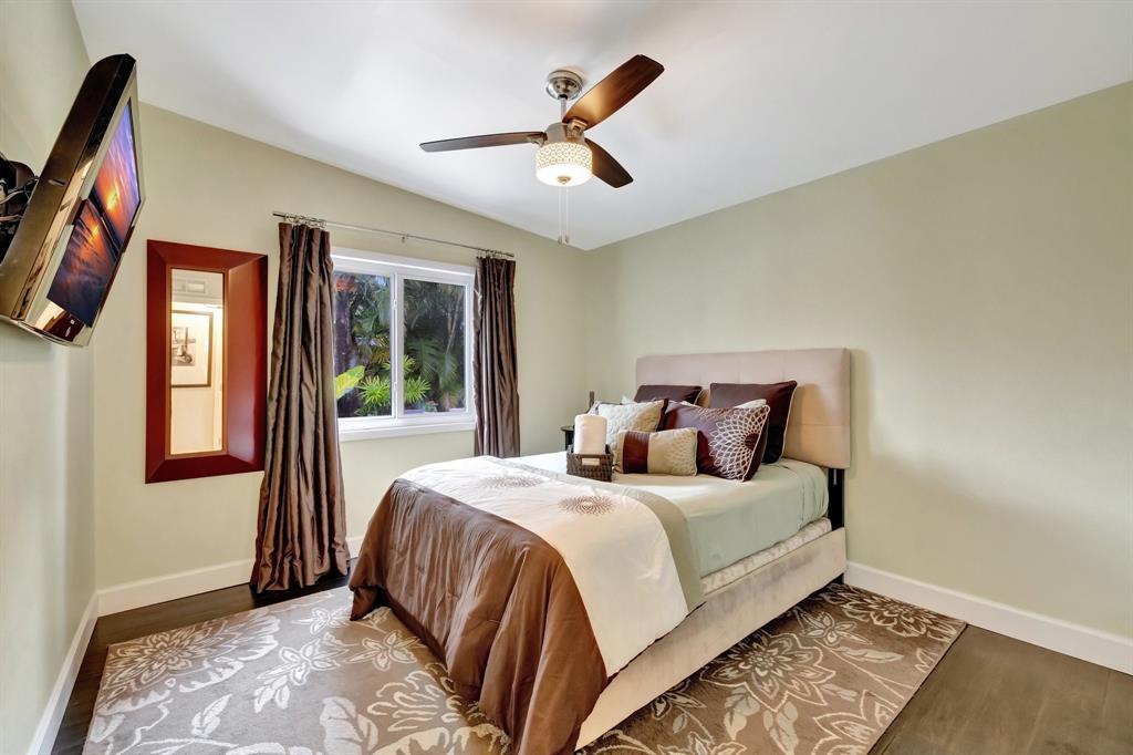 201 Northeast 28th Court Wilton Manors, FL 33334 - Photo 39 of 83 a bedroom with a large bed and a window