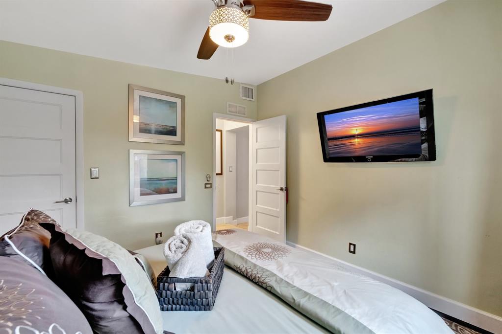 201 Northeast 28th Court Wilton Manors, FL 33334 - Photo 40 of 83 a bedroom with a bed and wooden floor