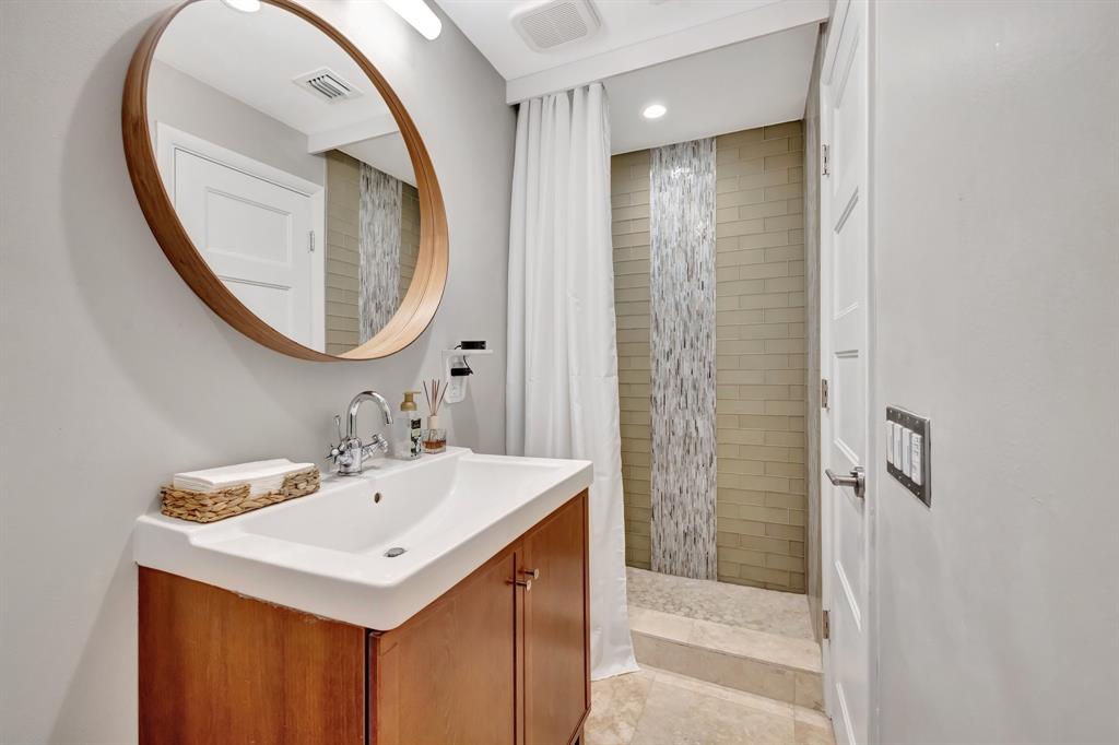 201 Northeast 28th Court Wilton Manors, FL 33334 - Photo 41 of 83 a bathroom with a sink a mirror and a shower