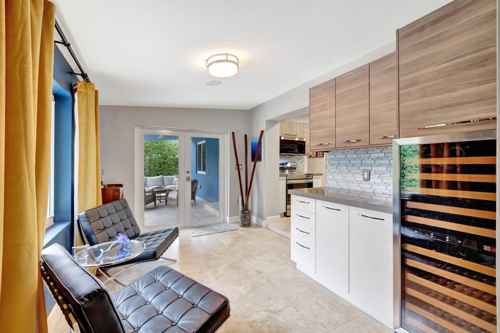 201 Northeast 28th Court Wilton Manors, FL 33334 - Photo 43 of 83 a living room with stainless steel appliances furniture a rug and a kitchen view