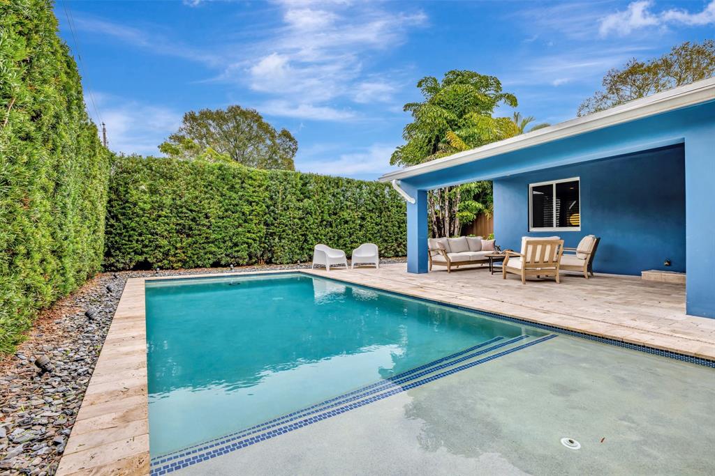 201 Northeast 28th Court Wilton Manors, FL 33334 - Photo 55 of 83 a swimming pool with outdoor seating and yard