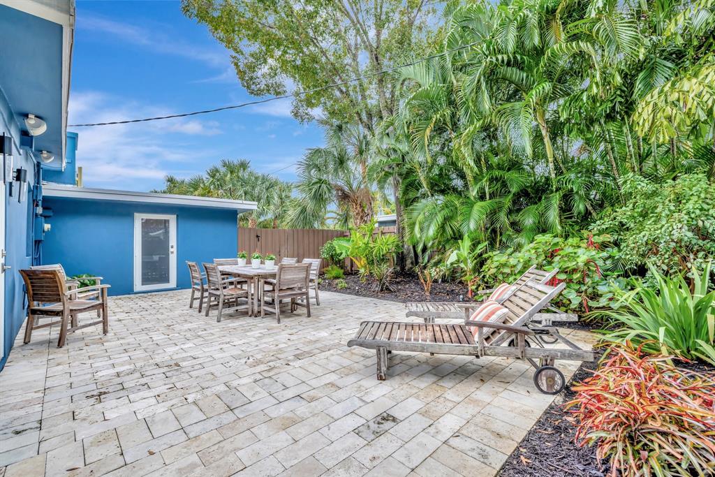 201 Northeast 28th Court Wilton Manors, FL 33334 - Photo 57 of 83 a view of a patio with table and chairs and potted plants