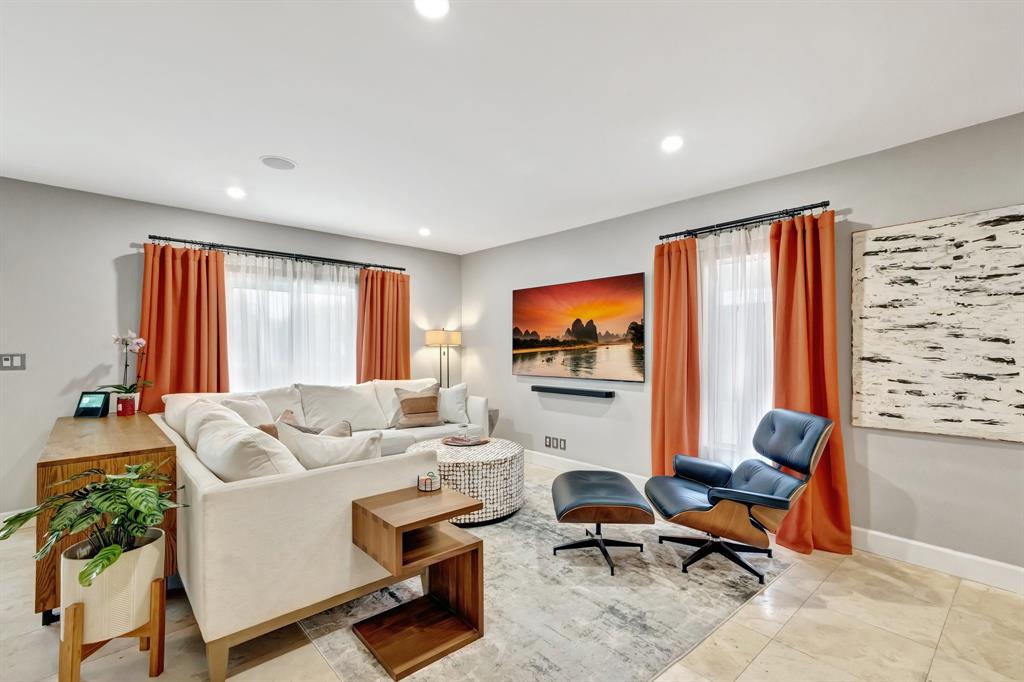 201 Northeast 28th Court Wilton Manors, FL 33334 - Photo 6 of 83 a living room with furniture a large window and a flat screen tv