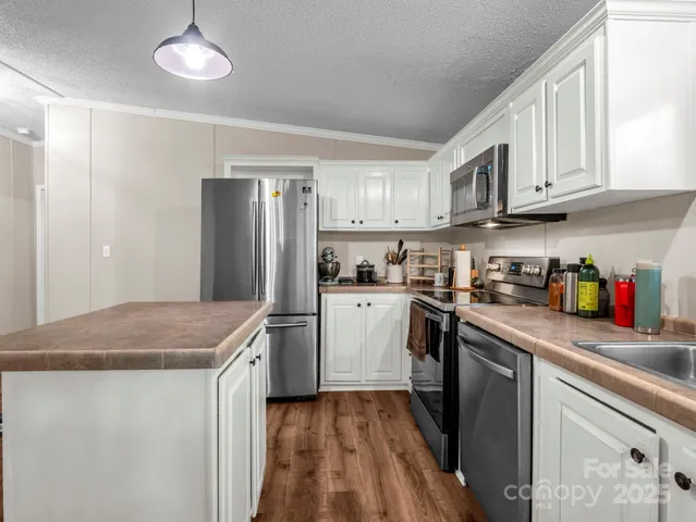 a kitchen that has a sink and a stove in it