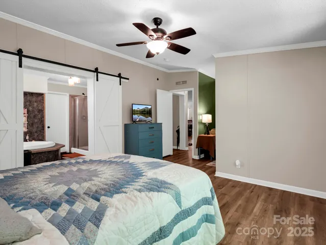 a spacious bedroom with a bed and a large window