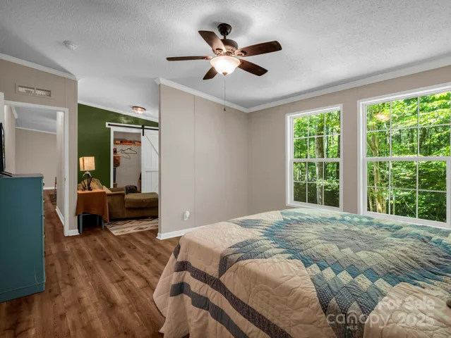 a living room with furniture cabinets and a window