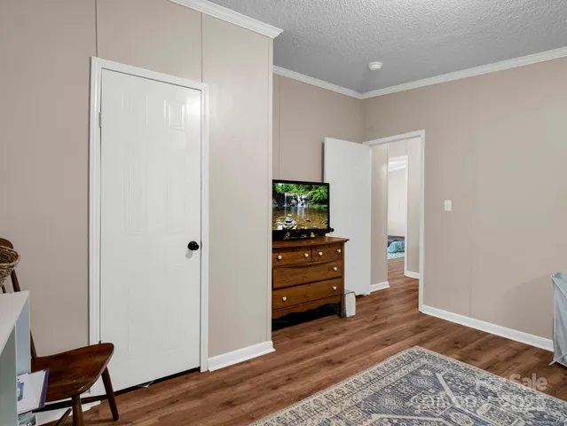 a view of a bird sitting in a backyard of a house