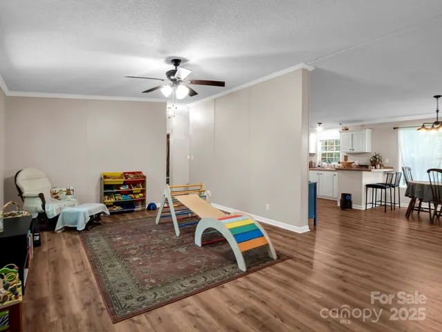 a bedroom with furniture and a large window