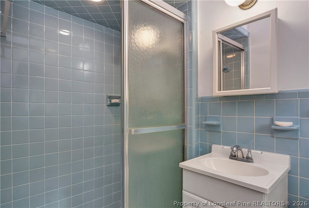 5219 McLeod Road Lumberton, NC 28358 - Photo 20 of 33 a bathroom with a sink a mirror and shower