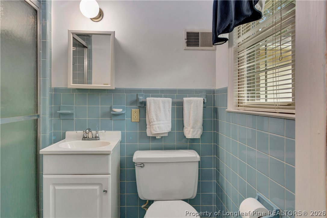 5219 McLeod Road Lumberton, NC 28358 - Photo 21 of 33 a bathroom with a toilet sink and mirror
