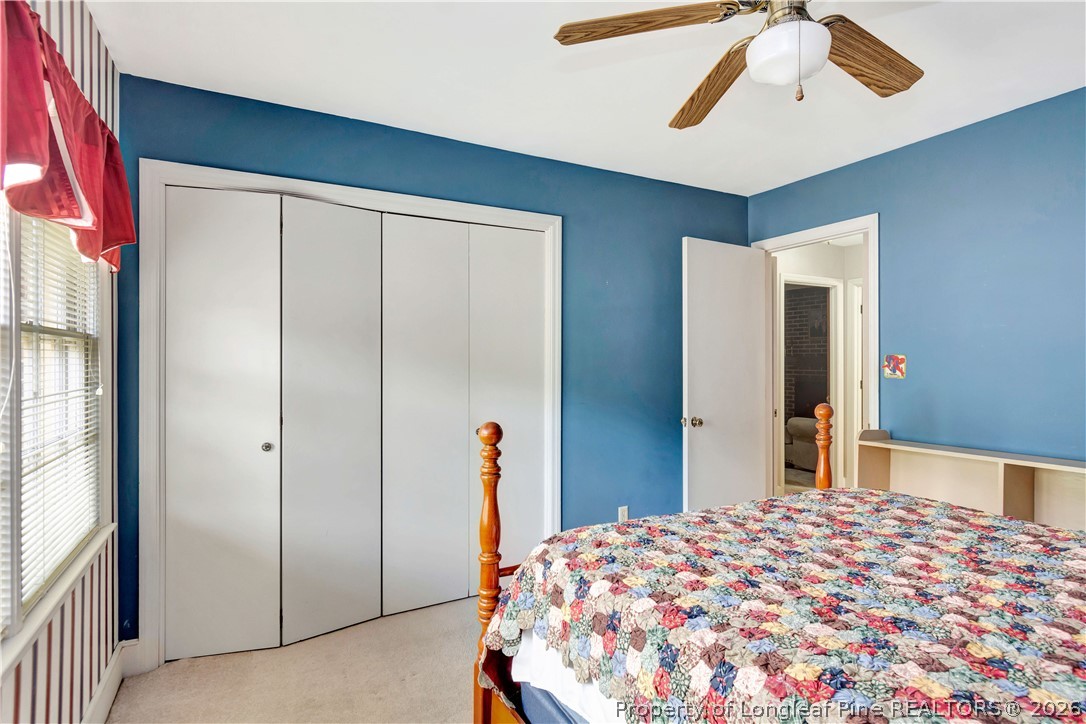 5219 McLeod Road Lumberton, NC 28358 - Photo 24 of 33 a bedroom with a bed and a chandelier