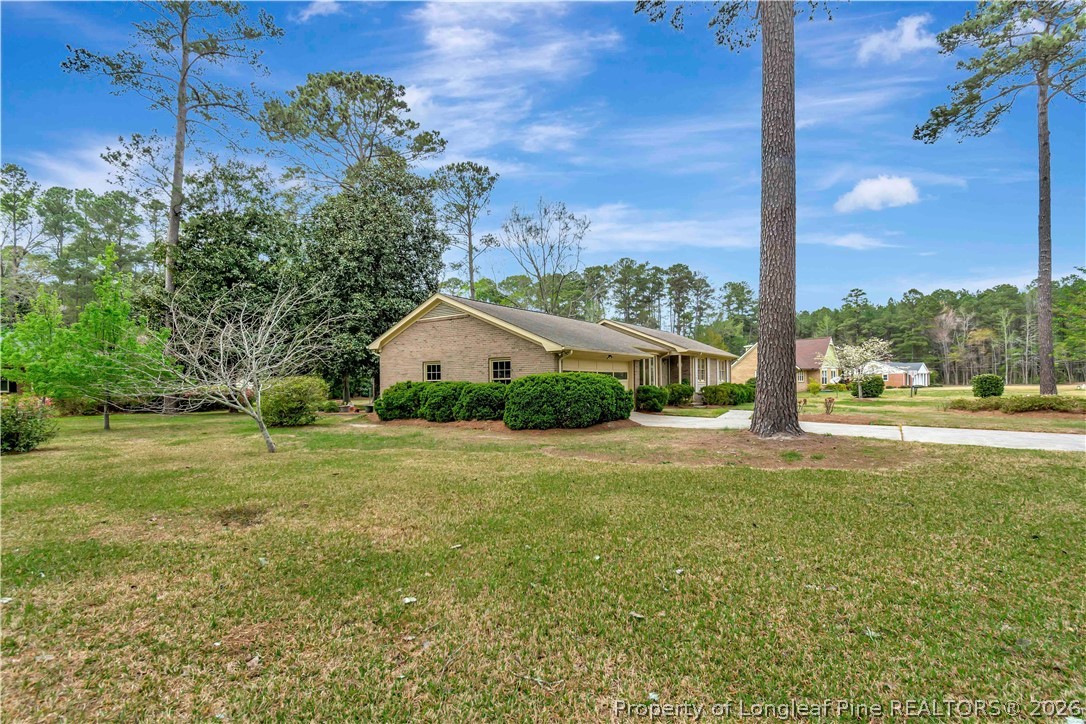 5219 McLeod Road Lumberton, NC 28358 - Photo 3 of 33 a view of a house with a big yard and palm trees