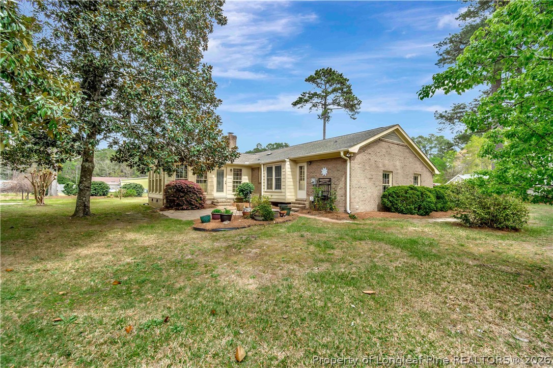 5219 McLeod Road Lumberton, NC 28358 - Photo 32 of 33 a view of a house with backyard and sitting area
