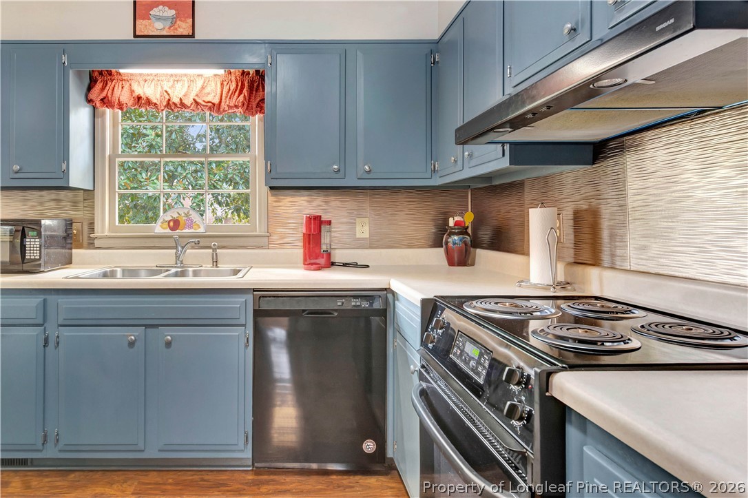 5219 McLeod Road Lumberton, NC 28358 - Photo 6 of 33 a kitchen with a sink stove top oven and cabinets
