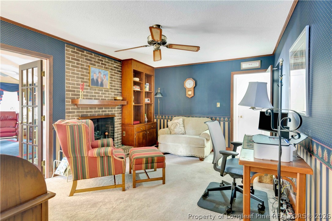 5219 McLeod Road Lumberton, NC 28358 - Photo 10 of 33 a living room with furniture a fireplace and a flat screen tv