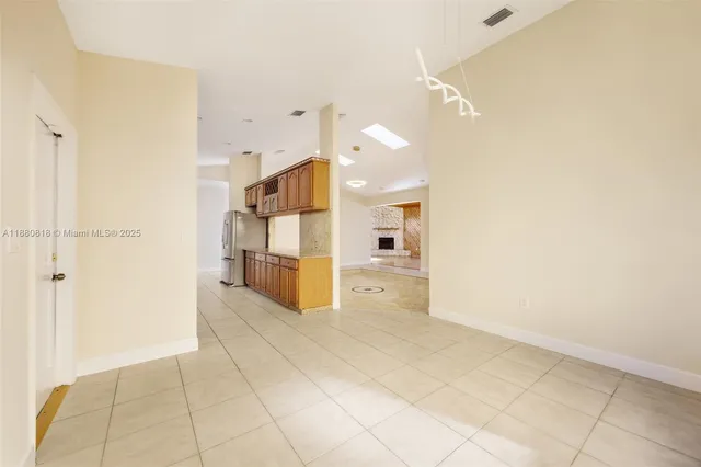 a view of a kitchen with a refrigerator and a sink