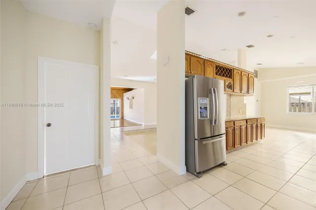 a kitchen with granite countertop a refrigerator and a sink